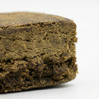 Gros plan sur la texture sableuse et d'un brun profond du Surver Hash CBD bio. Qualité premium