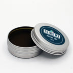 Boite metal Trikome Baume CBD 20 ml ouverte avec couvercle pose a cote sur fond blanc.