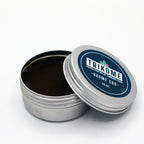 Boite metal Trikome Baume CBD 40 ml ouverte avec couvercle pose a cote sur fond blanc.